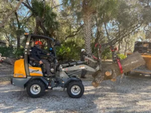 Loader carrying a heavy log off the job site