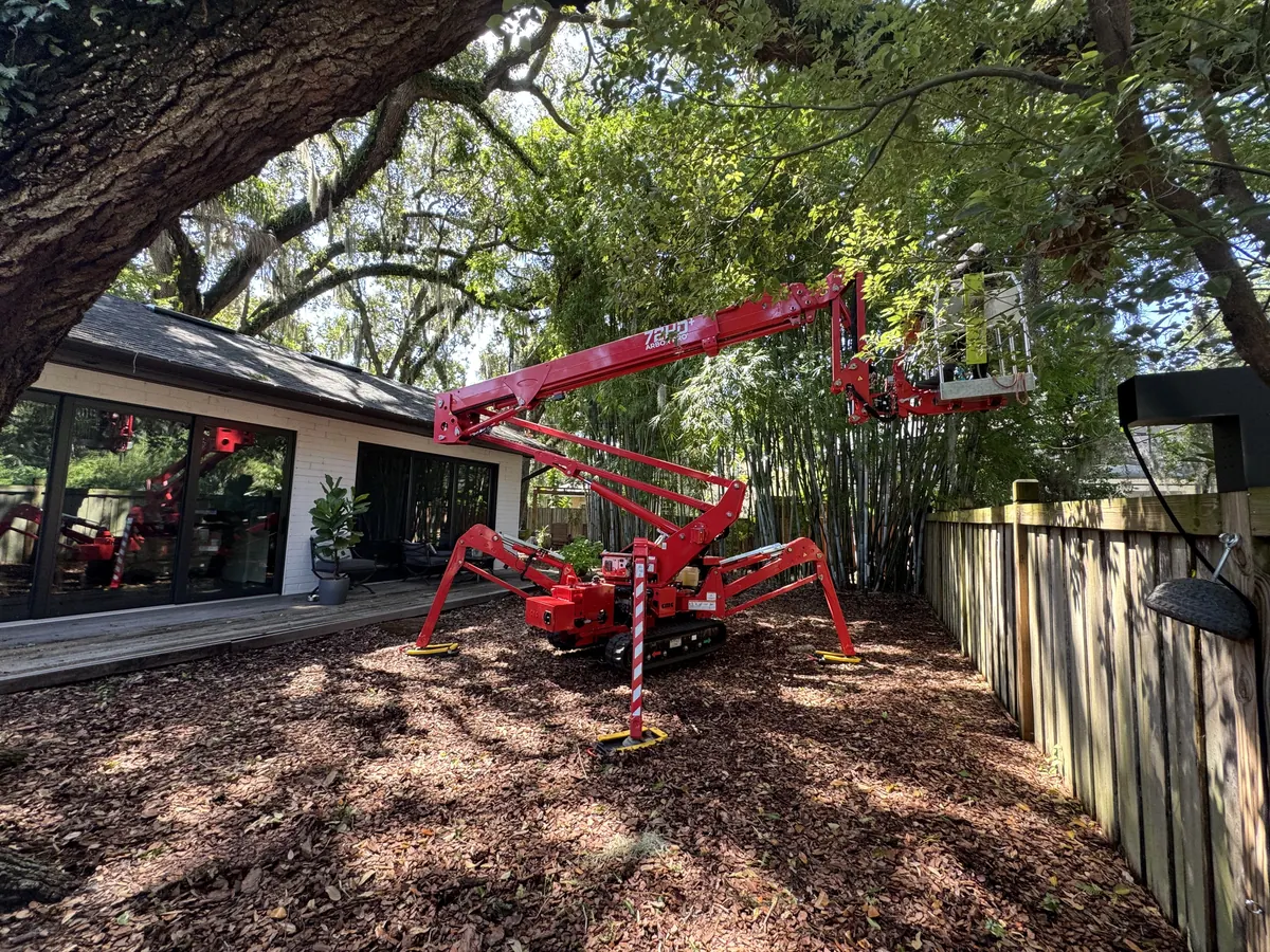 Kevin&rsquo;s Tree Service CMC spider lift set up for tree work in a residential backyard